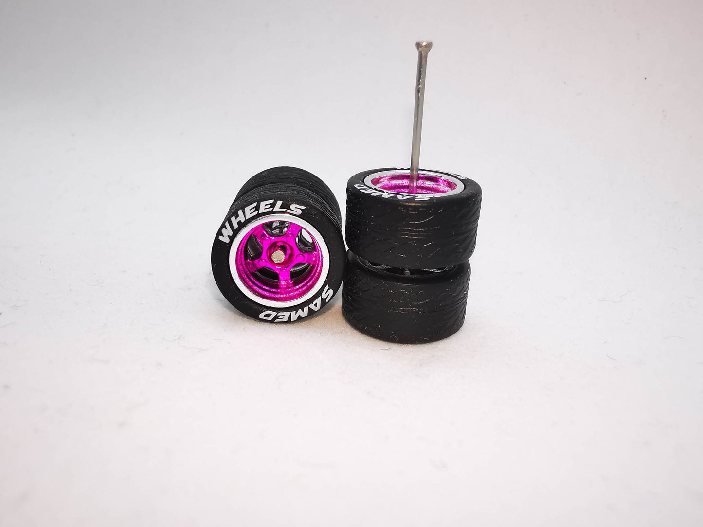 5 bolt 12 mm pink chrome ring, black tire with lettering